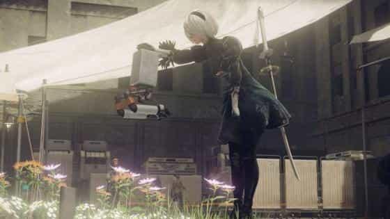 Скриншот, на котором главный герой 2B гладит маленького робота в Nier: Automata
